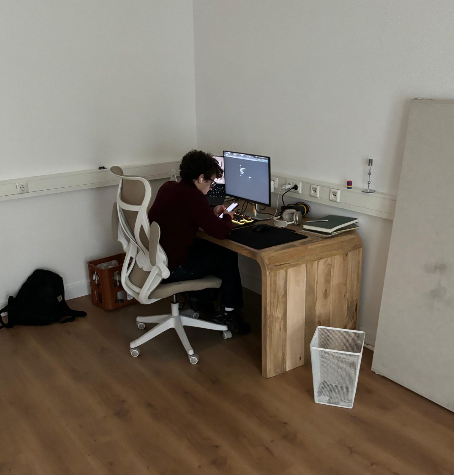 Team member working focused at a wooden desk setup