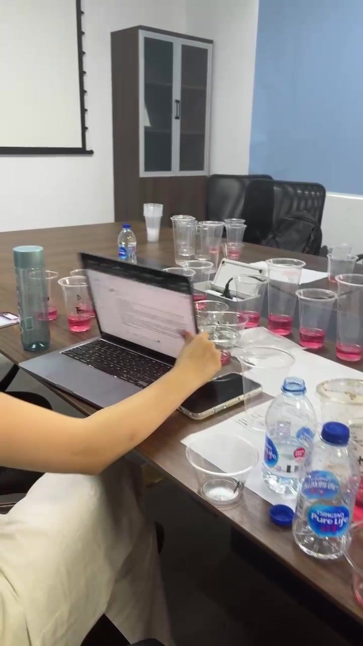 R&D tasting session with sample cups around a laptop